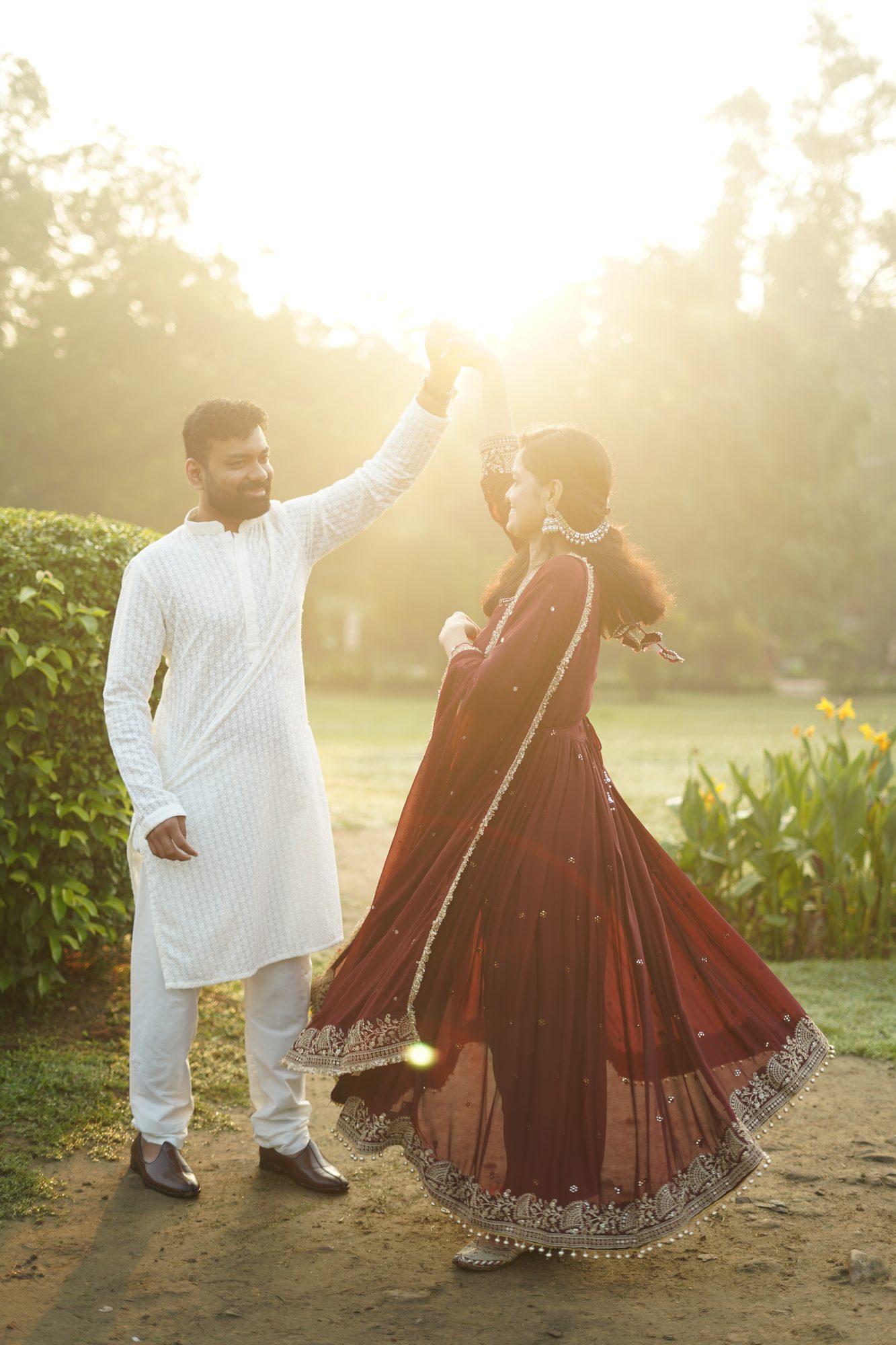 Shubham twirling Riya in a sunlit garden